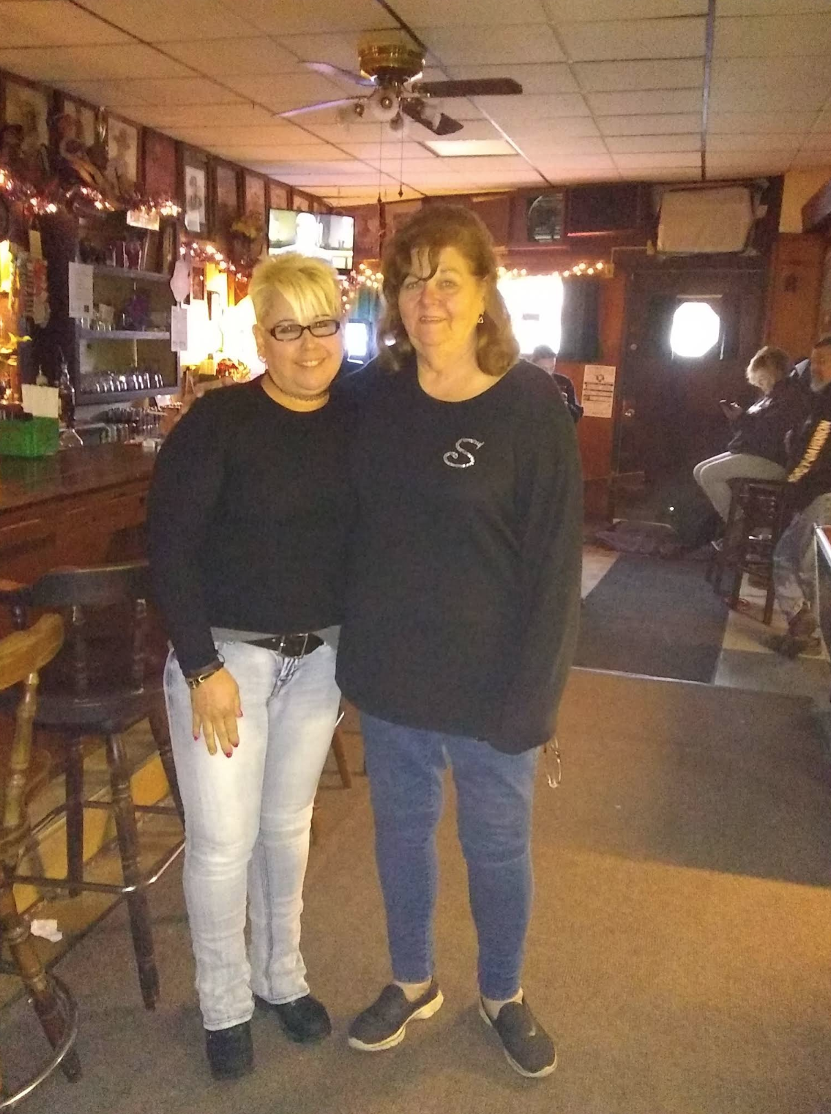 Two women standing inside The Ugly Broad.
